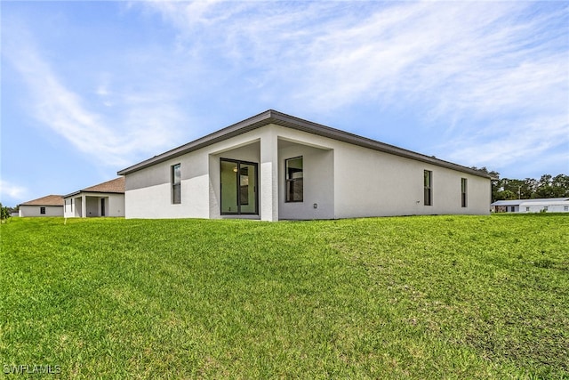 rear view of property with a yard