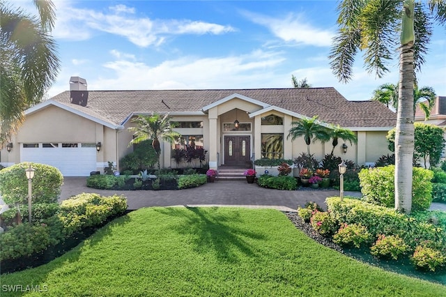 view of front of home featuring a garage and a front yard