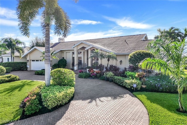 single story home with a garage and a front yard