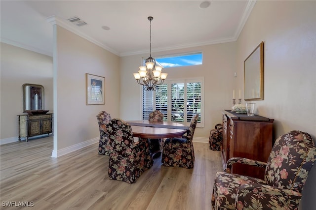 dining space with crown molding, a chandelier, and light hardwood / wood-style floors