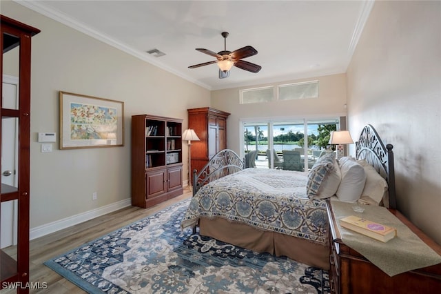 bedroom featuring wood-type flooring, ornamental molding, and ceiling fan