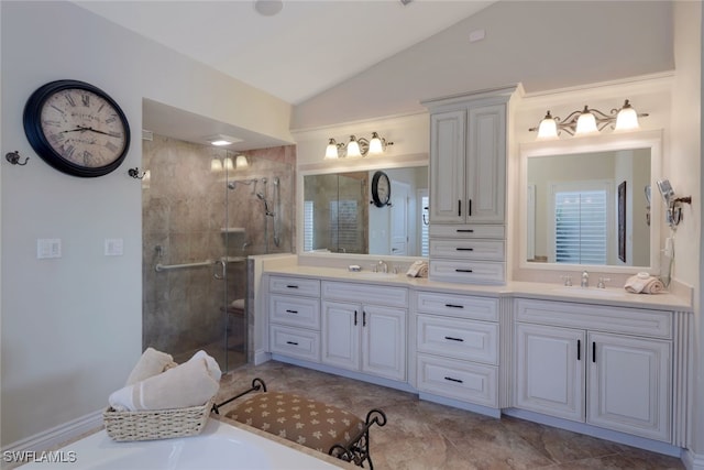 bathroom featuring vanity, vaulted ceiling, and a shower with shower door