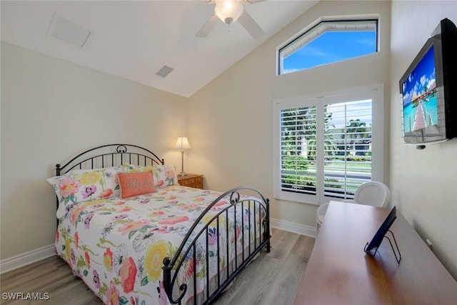 bedroom with vaulted ceiling, ceiling fan, and light wood-type flooring