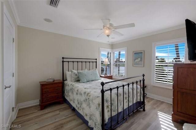 bedroom with crown molding, ceiling fan, and light wood-type flooring