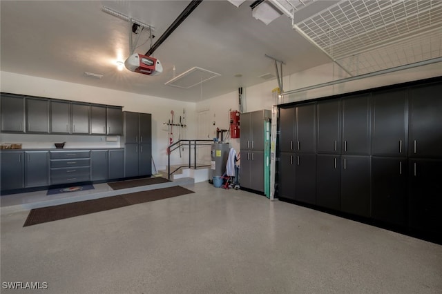 garage with a garage door opener and electric water heater