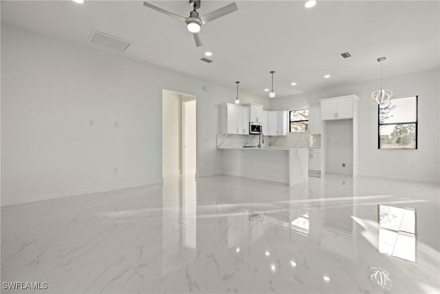 unfurnished living room featuring ceiling fan