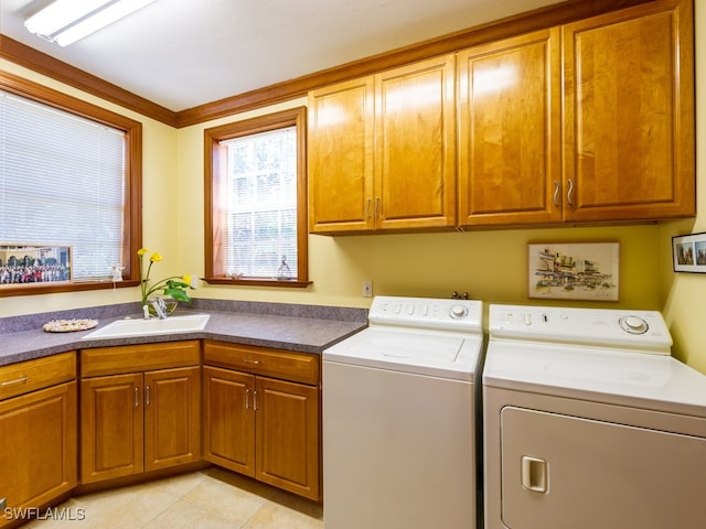 washroom featuring cabinets, light tile patterned floors, separate washer and dryer, and sink