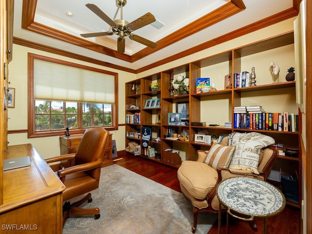 home office with a raised ceiling, ceiling fan, dark hardwood / wood-style flooring, and ornamental molding