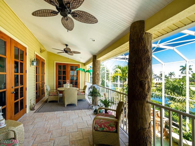 exterior space featuring french doors, a water view, and ceiling fan