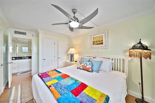 bedroom with light wood-type flooring, crown molding, connected bathroom, and ceiling fan