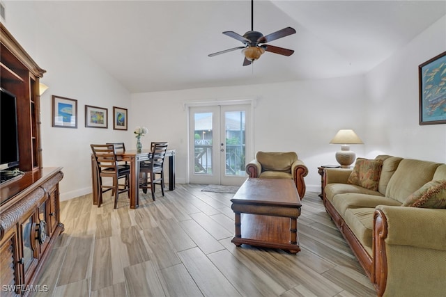 living room featuring lofted ceiling, ceiling fan, light wood-type flooring, and french doors