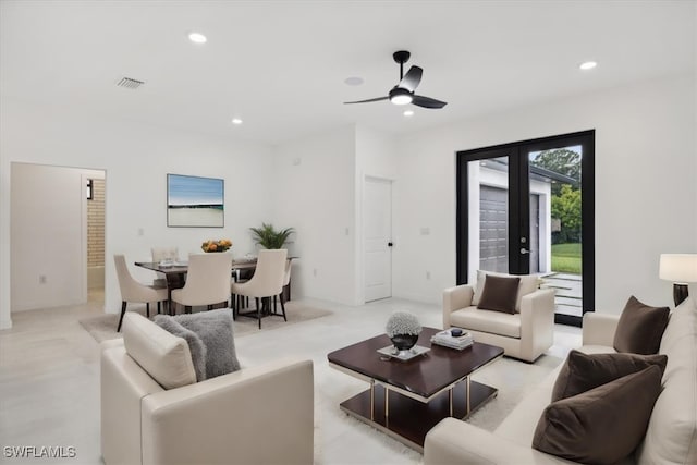 carpeted living room with ceiling fan and french doors