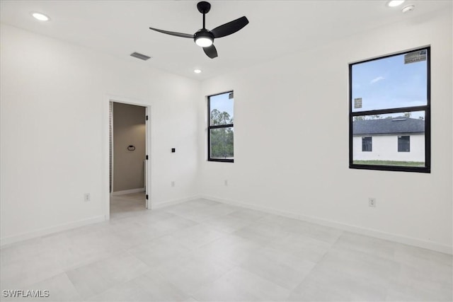 spare room with plenty of natural light, recessed lighting, and visible vents