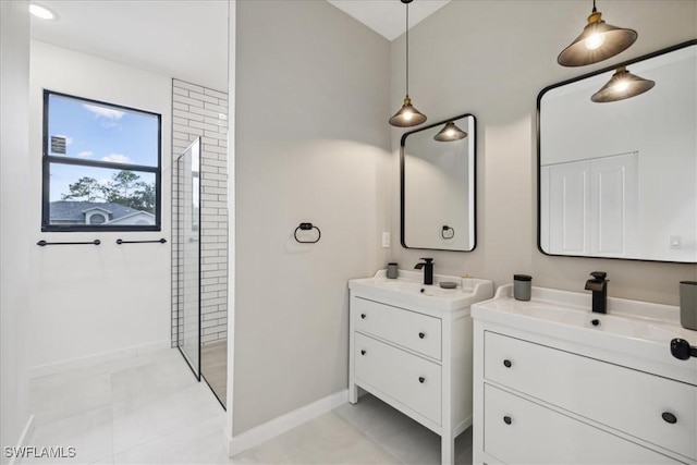 bathroom featuring a sink, two vanities, baseboards, and walk in shower