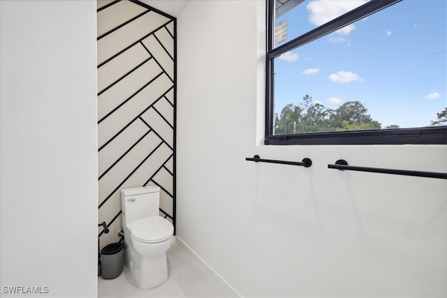 bathroom with toilet and tile patterned flooring