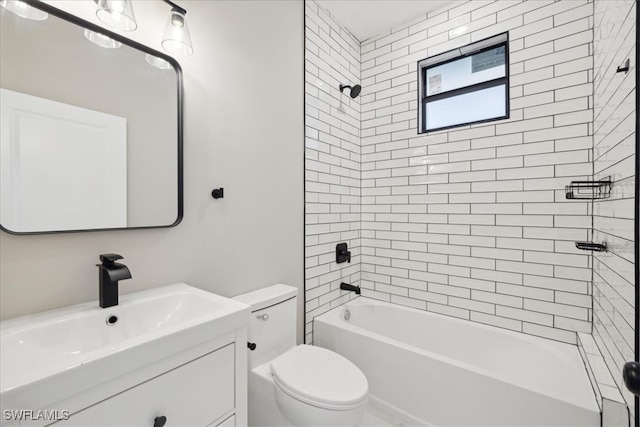 full bathroom featuring tiled shower / bath, toilet, and vanity