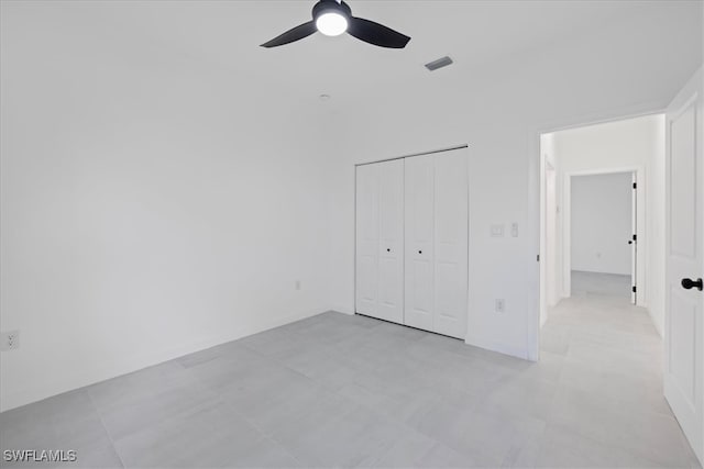 unfurnished bedroom with a closet and ceiling fan