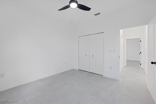 unfurnished bedroom with visible vents, a closet, and ceiling fan