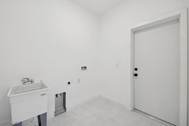 laundry room featuring baseboards, laundry area, hookup for a washing machine, hookup for an electric dryer, and a sink