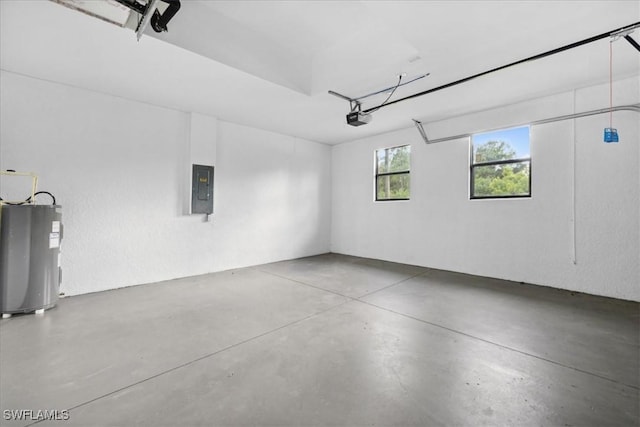 garage featuring electric panel, electric water heater, and a garage door opener