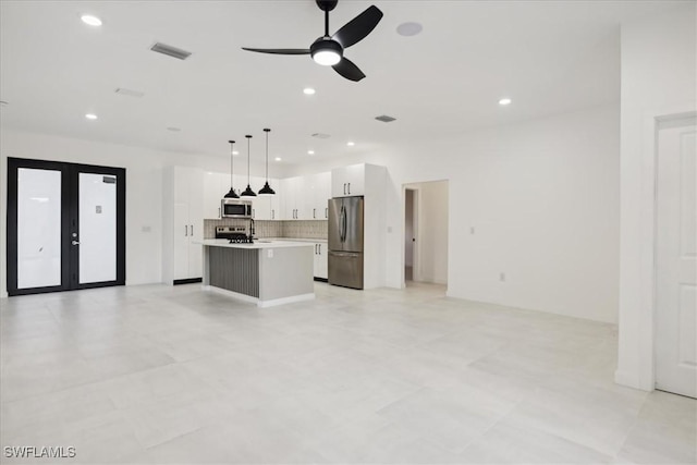 unfurnished living room featuring visible vents, recessed lighting, french doors, and ceiling fan