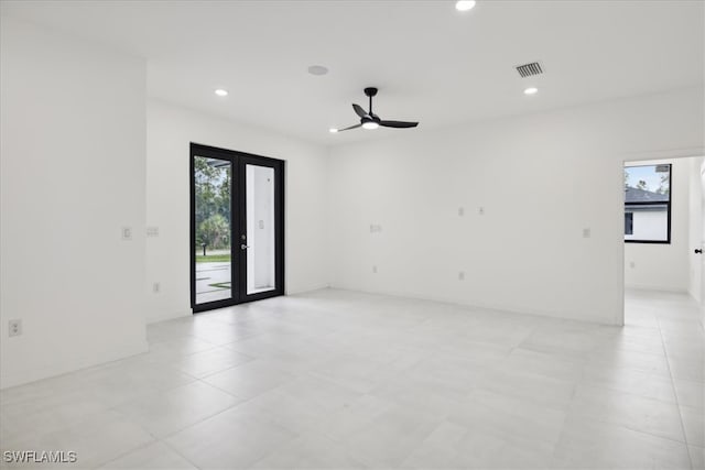 spare room featuring ceiling fan and french doors