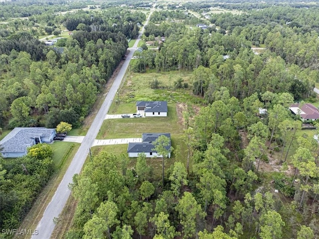 birds eye view of property with a wooded view