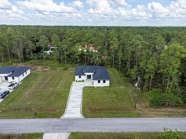 drone / aerial view featuring a wooded view