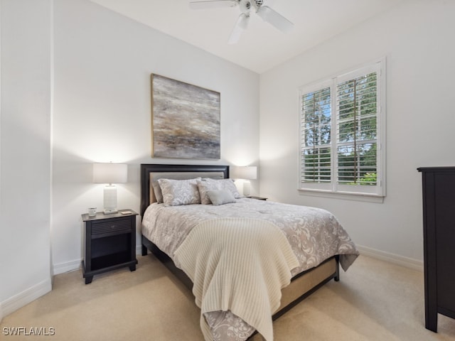 bedroom with ceiling fan and light colored carpet