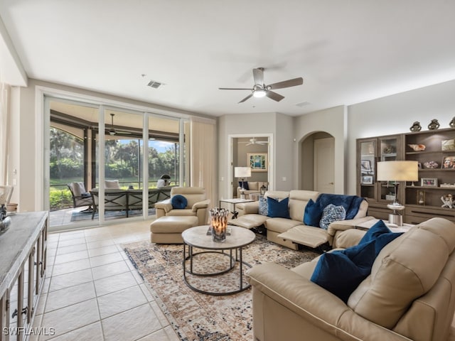 tiled living room featuring ceiling fan