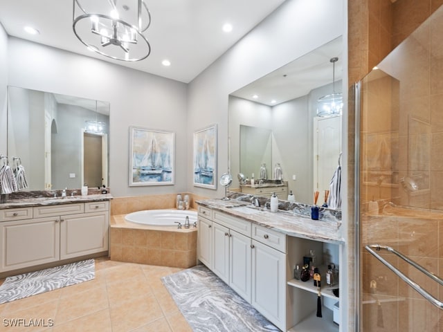 bathroom with independent shower and bath, vanity, a chandelier, and tile patterned floors