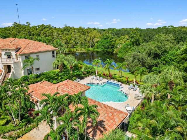 view of swimming pool featuring a patio and a water view