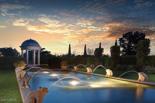 view of pool at dusk