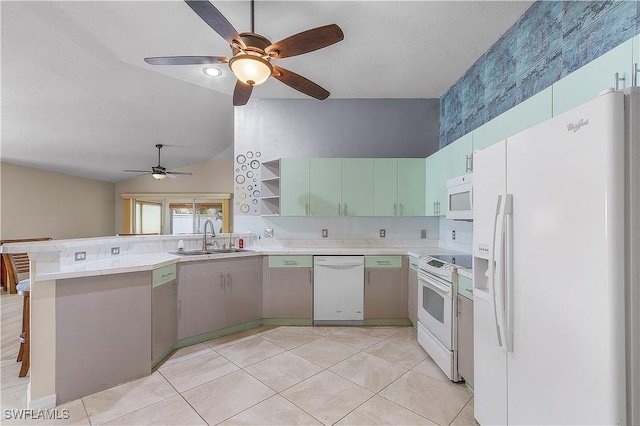 kitchen featuring white appliances, sink, vaulted ceiling, kitchen peninsula, and a breakfast bar area