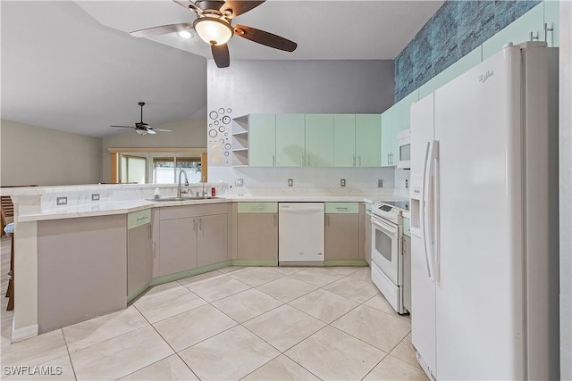 kitchen with sink, kitchen peninsula, lofted ceiling, white appliances, and light tile patterned floors