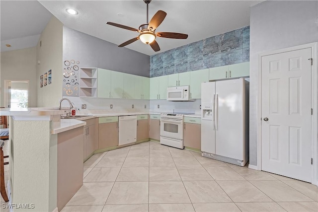 kitchen with kitchen peninsula, white appliances, ceiling fan, sink, and light tile patterned flooring