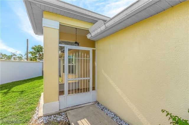 doorway to property with a yard