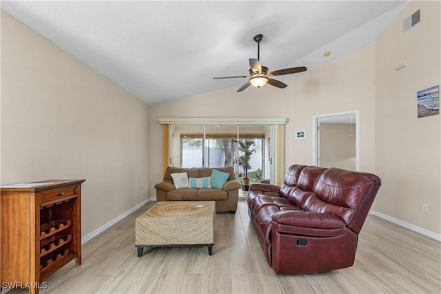 living room with ceiling fan, light hardwood / wood-style flooring, and vaulted ceiling