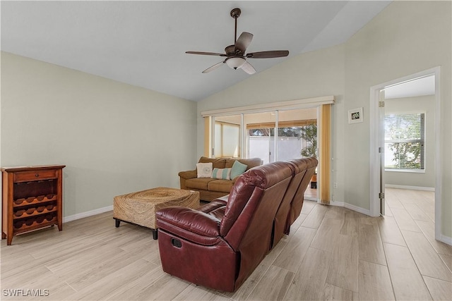 living room with ceiling fan, light wood-type flooring, and vaulted ceiling