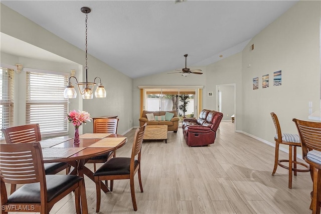 dining space featuring light hardwood / wood-style flooring, ceiling fan with notable chandelier, and lofted ceiling