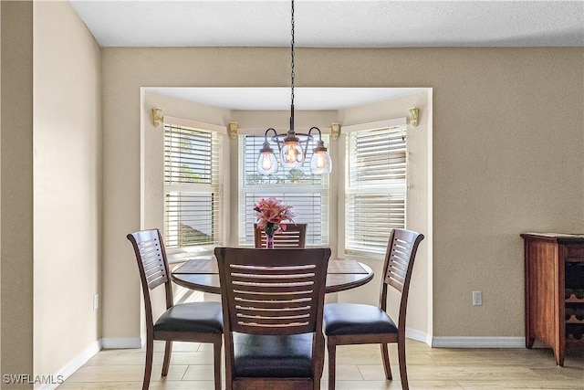 dining room featuring a chandelier and light hardwood / wood-style flooring