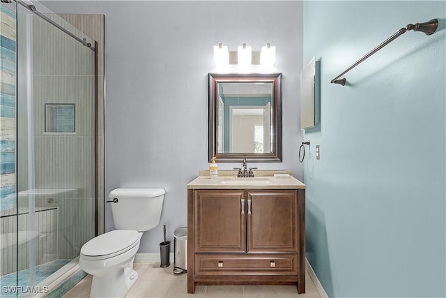 bathroom with tile patterned flooring, vanity, toilet, and walk in shower