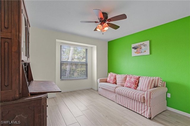 living room with light hardwood / wood-style floors and ceiling fan