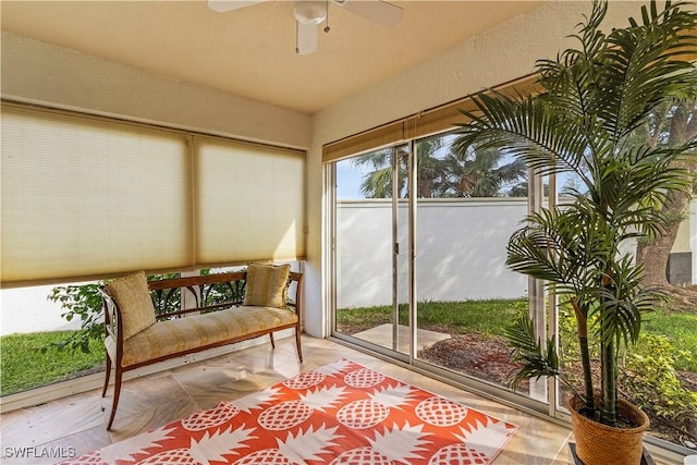 sunroom featuring ceiling fan