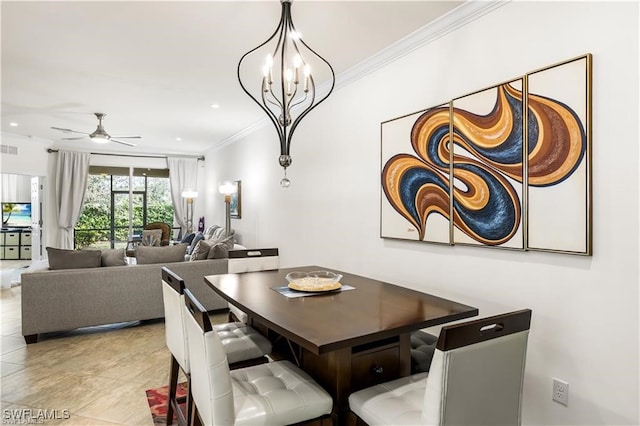 tiled dining room with ceiling fan with notable chandelier and ornamental molding