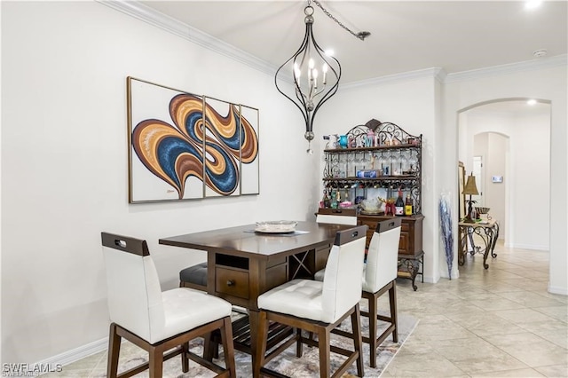 dining space featuring an inviting chandelier and crown molding