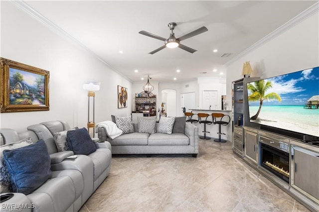 living room featuring ceiling fan and ornamental molding