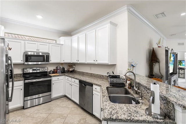 kitchen with stone countertops, white cabinetry, light tile patterned floors, sink, and appliances with stainless steel finishes