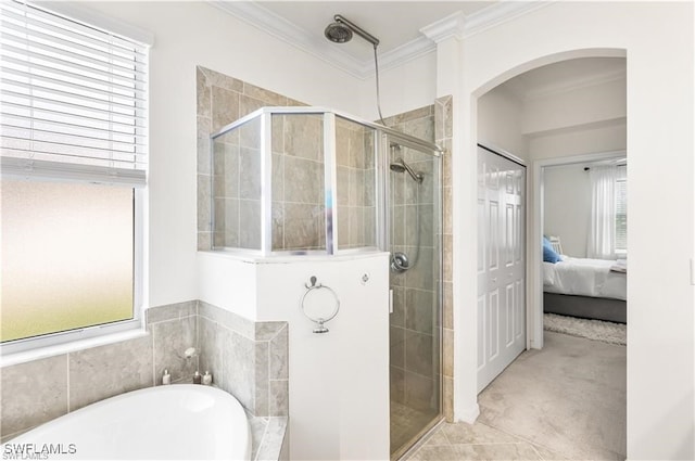 bathroom featuring crown molding and separate shower and tub