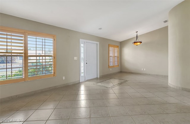 tiled entryway featuring vaulted ceiling